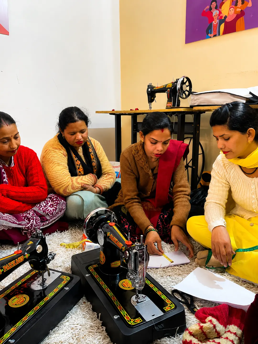 Women learning tailoring at a Nayi Shuruaat session